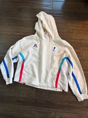 Le Coq Sportif Paris Olympics Cream Hoodie with Blue and Red Accent Stripes